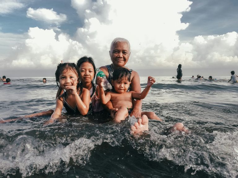 beautiful family splashing in the ocean